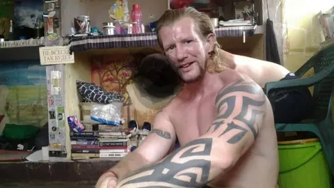 Nick and friend in prison cell