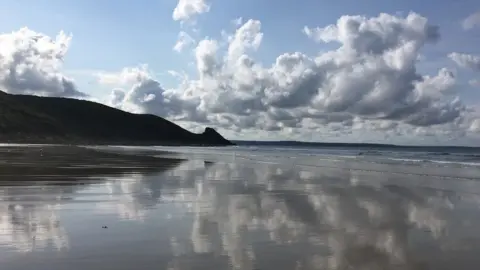 Sue Pasternak Clouds mirrored on Newgale beach in Pembrokeshire by Sue Pasternak