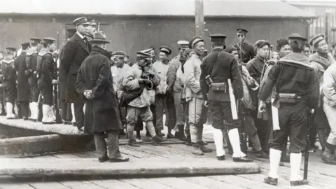 Getty Images Japanese troops with captured Chinese men and boys in then Shangdong, China