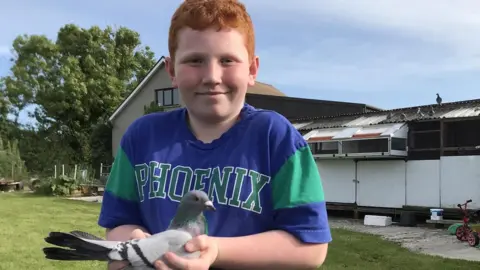 Alan Larkin Tom Larkin holds a pigeon