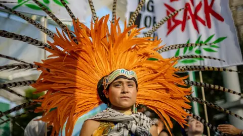 An activist dressed in tradition clothing at a COP28 march