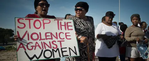AFP Women hold signs during a protest against ongoing violence against women, in Gugulethu, on May 21, 2016, about 20 Km from the centre of Cape Town.