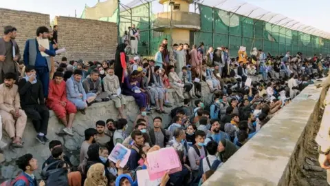 Reuters Crowds of people wait outside Kabul airport