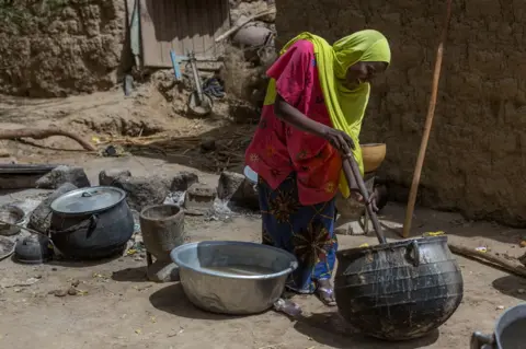 Aisha Augie-Kuta / WaterAid Fadouralaye Massaoudou stirs a pot in Norandé