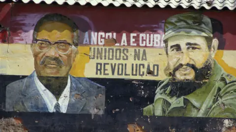 Getty Images Graffiti in Angola in 1987 of Cuban leader Fidel Castro (R) and Angolan leader António Agostinho Neto (L)