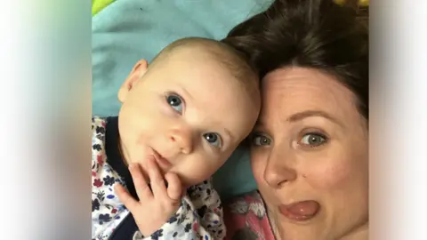 Cassandra Bodington Mother and baby looking up at the camera