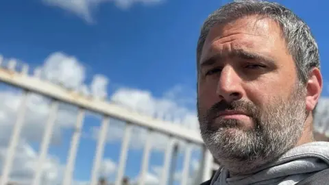 Simon Harris Man staring directly at the camera