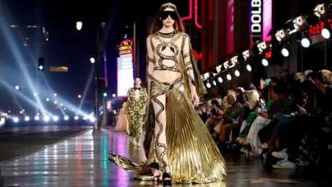 Reuters A model walks on the pavement of Hollywood Blvd during the Gucci Love Parade fashion show in Los Angeles, California