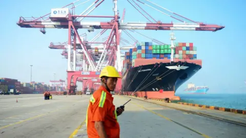 Getty Images Dock worker in front of ship