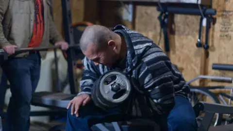 Tusitala "Tiny" Toese lifts weights during a Proud Boy gathering