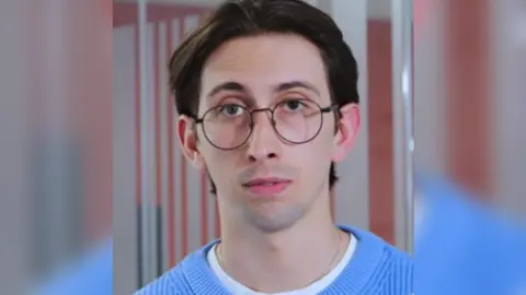 UWE Harry O'Higgins wearing a blue t-shirt and glasses