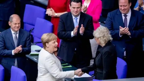 AFP Chancellor Merkel in Bundestag, congratulating new justice minister, 27 Jun 19