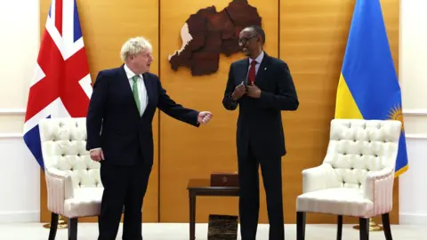 PA Media Boris Johnson and Paul Kagame