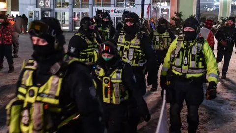 Getty Images Police officers in Ottawa's city centre on Saturday