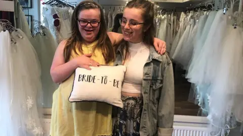 Liz Crowter Heidi and her sister Suzie in a wedding dress shop