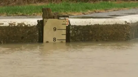 River level gauge showing the water is at level 8, the second highest on the measuring line