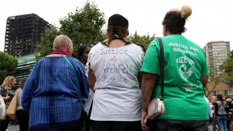 PA People attend a silent march to pay respect to those killed in the Grenfell Tower disaster