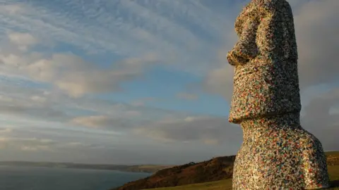 Rob Arnold An Easter Island-style sculpture coated with plastic waste