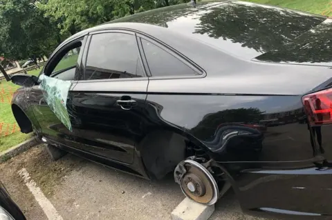 Steve Morrisroe A picture of the damaged auto on bricks.