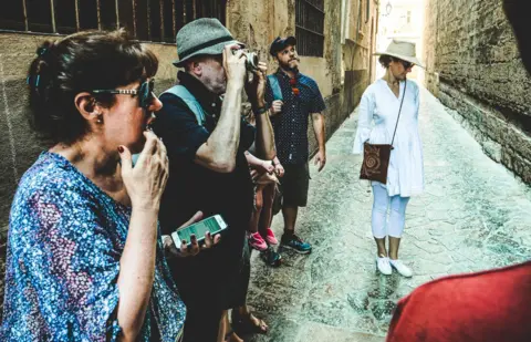 Dani Rotstein Dani showing tourists the groove on the church wall