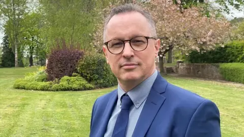 John Fairhall/BBC NSFT Chief Executive Stuart Richardson looking at the camera