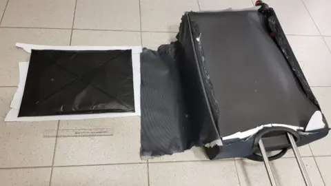 Department of Justice Suitcase with cocaine concealed