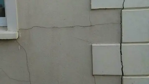 Mica Action Group Cracks in the wall of a house