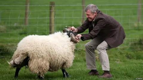 PA Media Willie Rennie on a visit to a farm during the 2017 Scottish council elections