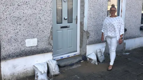 BBC Aysha Powell's outside her home