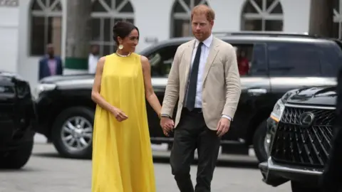 Getty Images Harry and Meghan arrive at State Governor House in Lagos