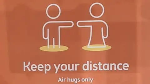 One of the signs about social distancing displayed at the school