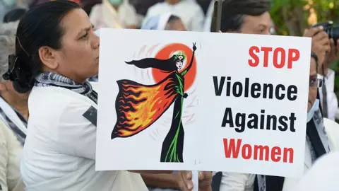 Getty Images Women attend a protest in Ahmedabad on March 20, 2015, in the wake of the gang-rape on an elderly nun.