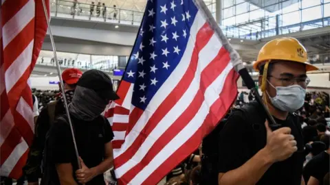 AFP/Getty Activists at Hong Kong airport carrying US flags, 9 August 2019