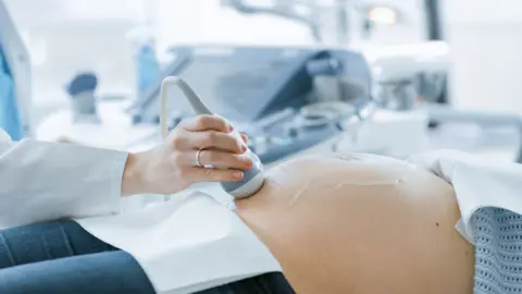 Getty Images Pregnant woman being examined
