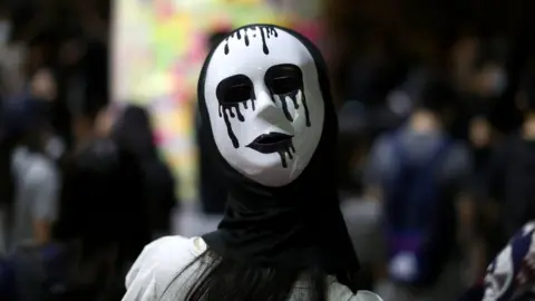 Reuters An anti-government protester wears a mask during a demonstration in Wong Tai Sin district, in Hong Kong