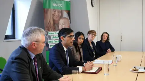 PA Media Prime Minister Rishi Sunak and Home Secretary Suella Braverman at the NSPCC offices in Leeds