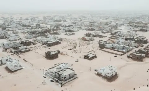 Getty Images This aerial view shows newly built houses and construction sites in the Saharawi area on the outskirts of Nouakchott, on March 14, 2023