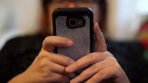 PA Media Woman using phone