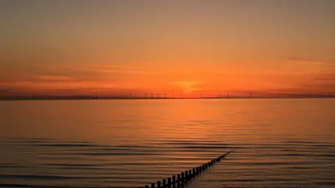 Natalie Clements Sunset over the offshore wind farm off Rhyl, courtesy of Natalie Clements