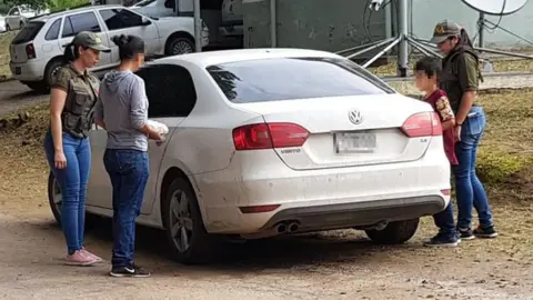Argentine police The rescued woman (second left) and her son (second right) are escorted by police officers