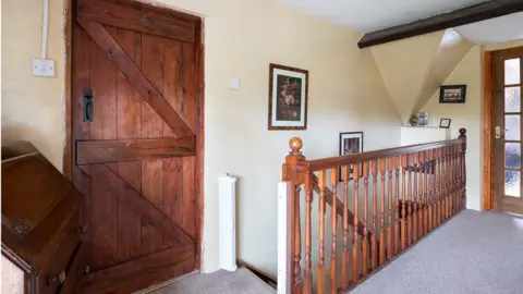 MARCUS NEWEY Image of an upstairs hallway