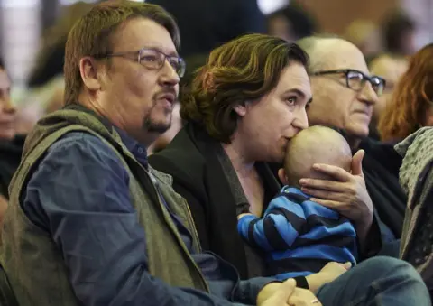 EPA Ada Colau kisses her baby next to Xavier Domenech in Barcelona, 11 November