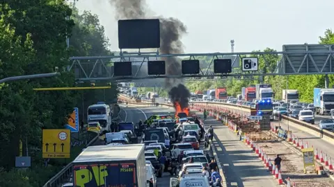 BBC Car on fire on M4, causing queue of traffic