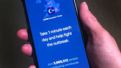 BBC A person holding a phone displaying the Covid-19 Symptom Study App