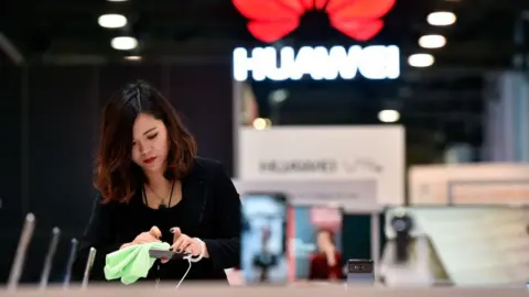 Getty Images Woman polishes Huawei phone