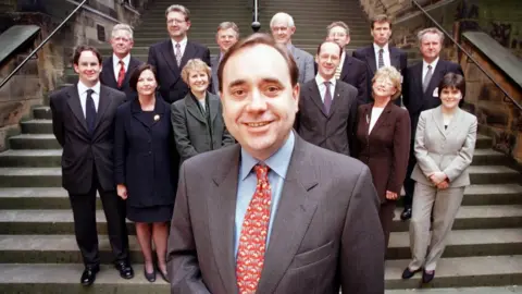 PA Media Alex Salmond with his SNP team in 1999