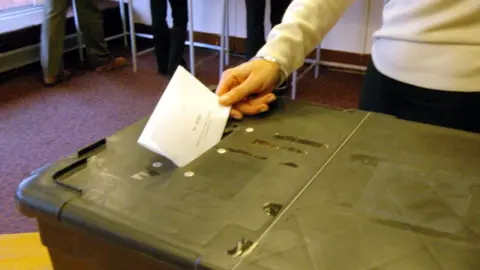 BBC Woman voting at ballot box