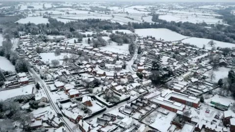 PA Media Snow covering the village of Oulton in Staffordshire