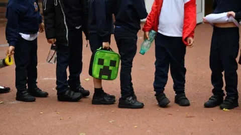 Getty Images Children in a queue outside school