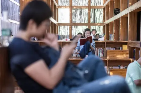 FRED DUFOUR/AFP/Getty Images People reading inside Liyuan Library